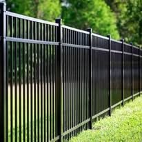 Three-rail black aluminum fence installed beside a lawn