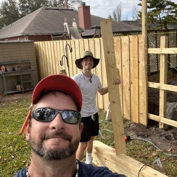 Tommy and T.A. building a wood fence for 4 Tradesmen Fencing