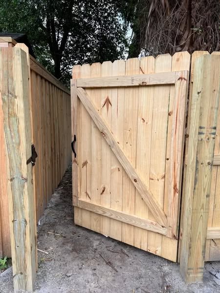 Custom wood privacy gate with diagonal bracing and 6×6 posts built by 4 Tradesmen Fencing