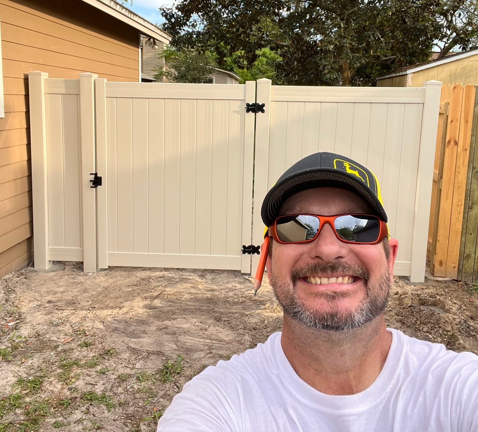 Tan vinyl privacy fence and matching gate installed by 4 Tradesmen Fencing in Jacksonville